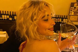 sabrina carpenter goes bra free in a backless ruby red dress while sipping wine 68757c1099706